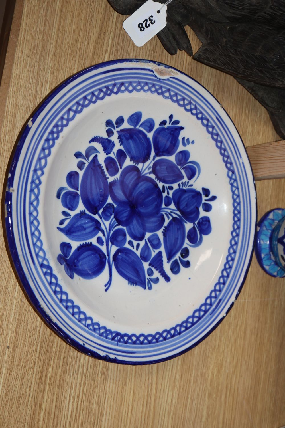 Three tin glazed earthenware dishes and a Persian stone paste vase, height 39cm